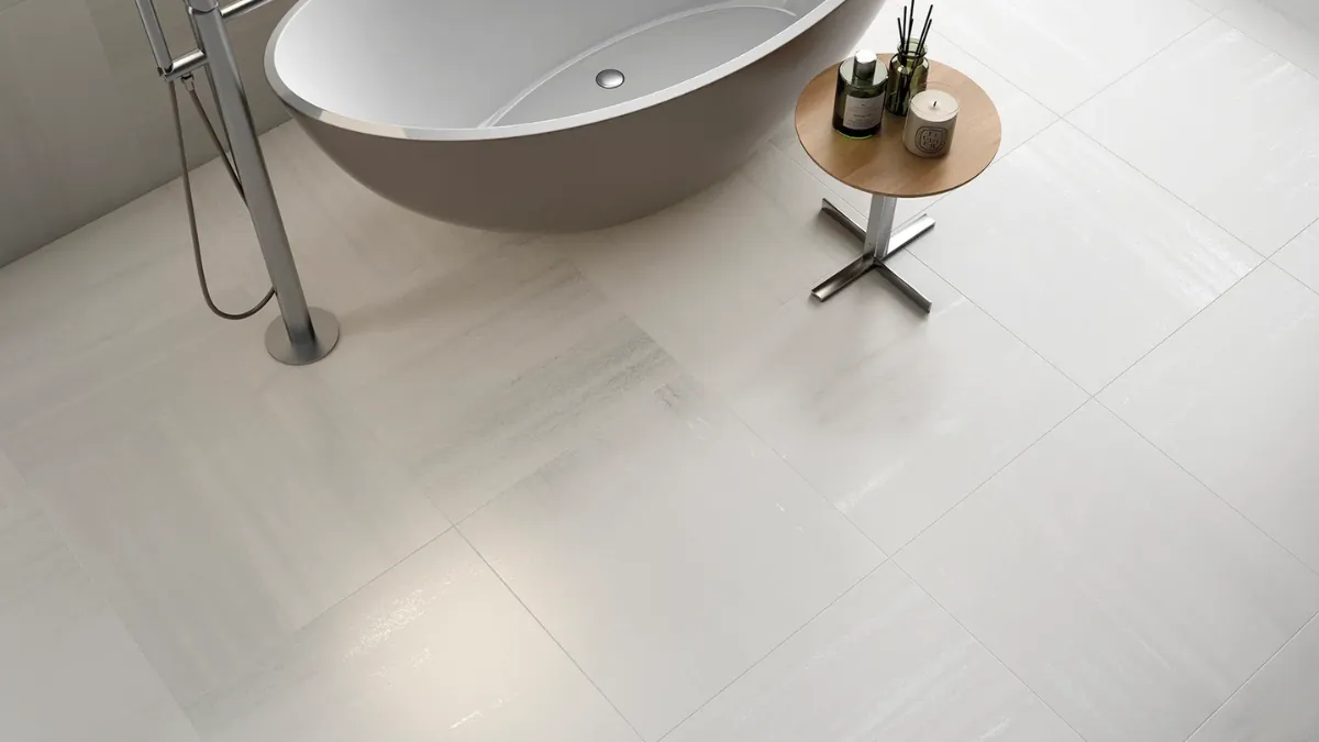 Small bathroom tiled floor-to-ceiling in large-format 600x600mm porcelain with thin tonal grout